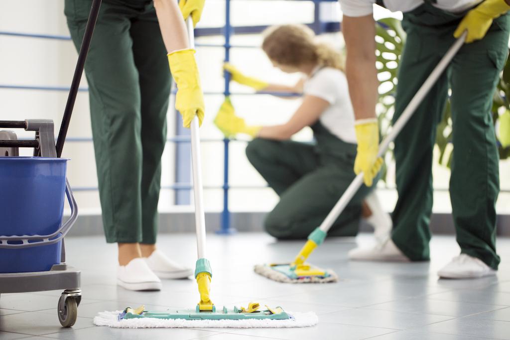 Three people cleaning an office