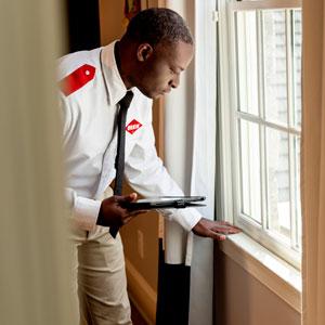 An Orkin Pro inspecting the windows in a customer's home