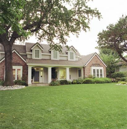 Protected home and green grassy lawn