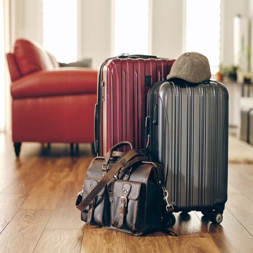 Holiday Travel & Guests - three pieces of luggage placed in a living room