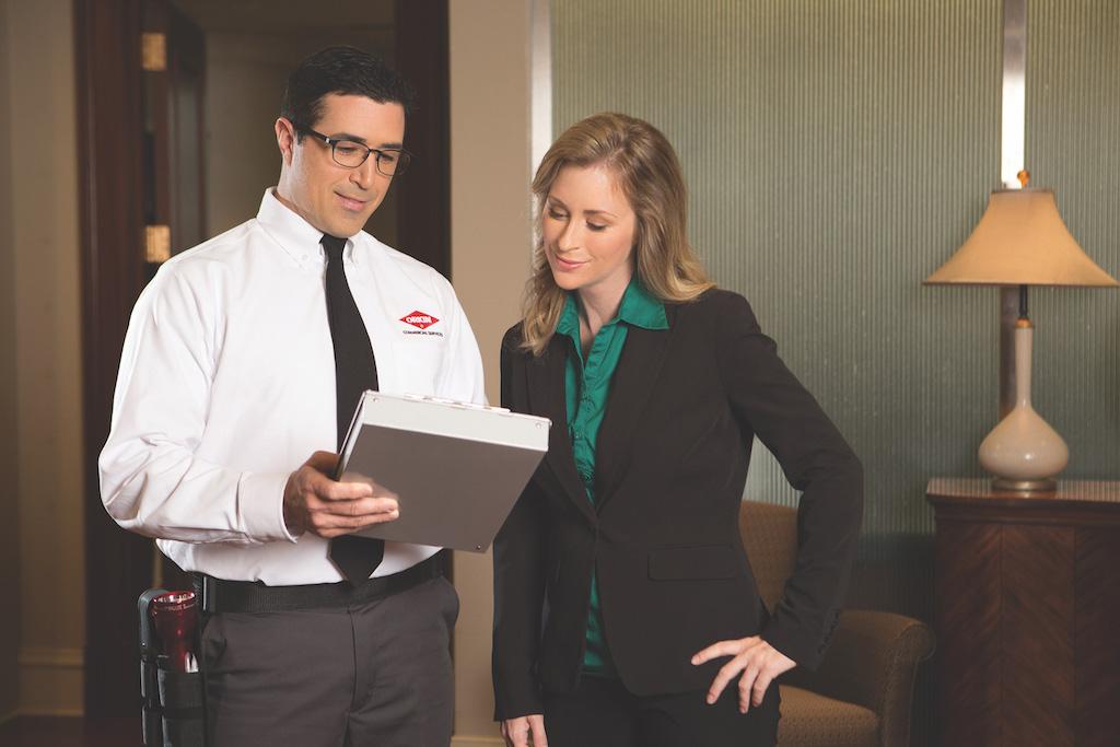 Orkin Pro reviewing documents with customer