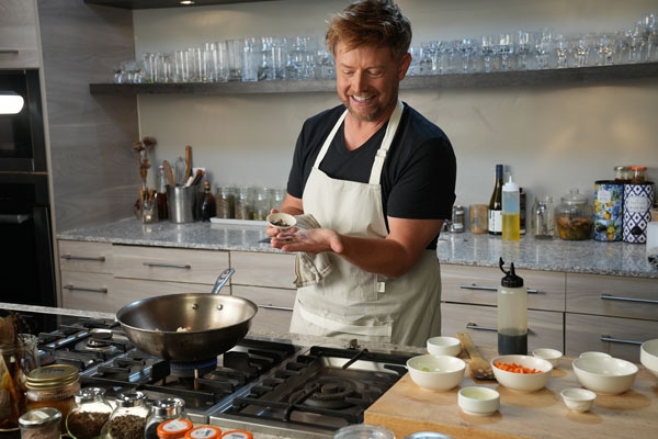 Bug Bites - Chef Richard Blais looking at a scorpion prior to adding them to the scorpion fried rice