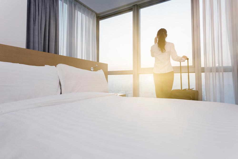 Business Woman in Hotel Room with Luggage